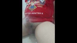 A boy masturbating with showerhead